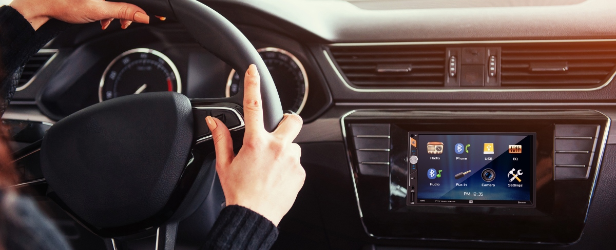 dm724 radio mounted in car dash with woman holding steering wheel