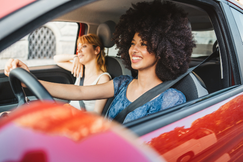 women in red car enjoying their car audio experience